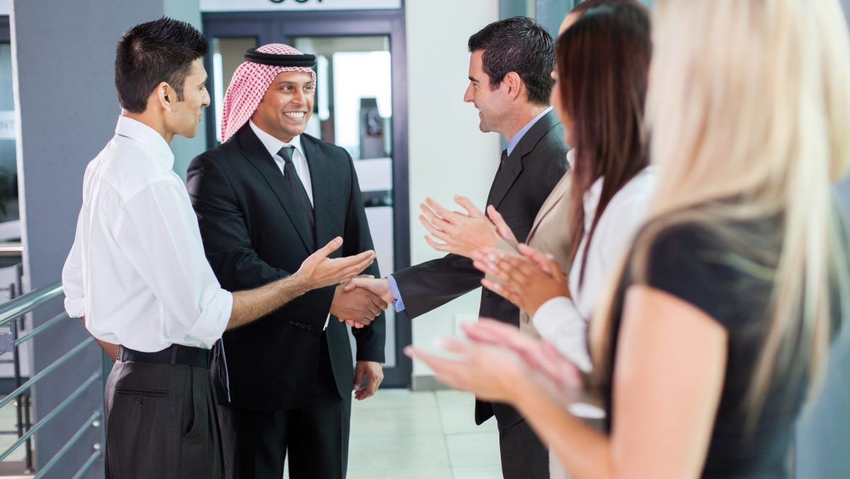 translator introducing arabian businessman to business partners